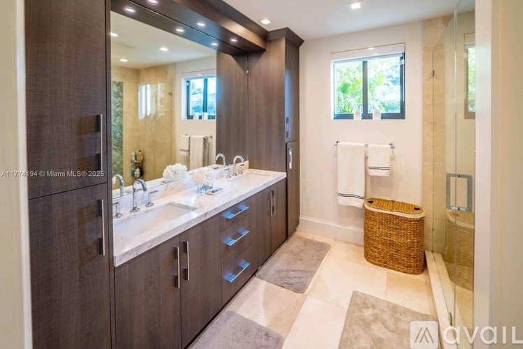 A bathroom with a double sink vanity and a large mirror.