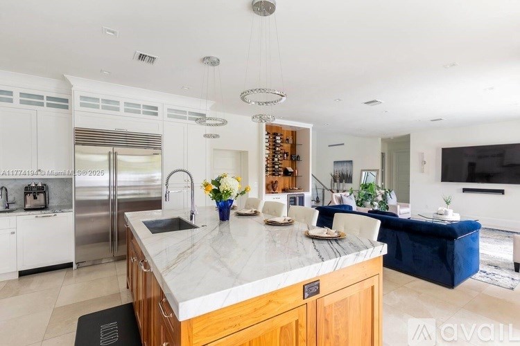 A kitchen with a marble countertop and a sink.