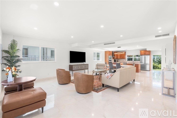 A living room with a white floor and furniture.