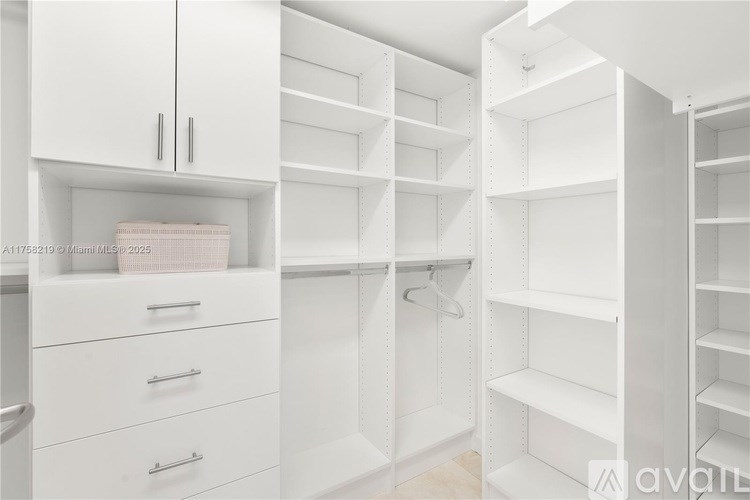 A white closet with shelves and drawers.