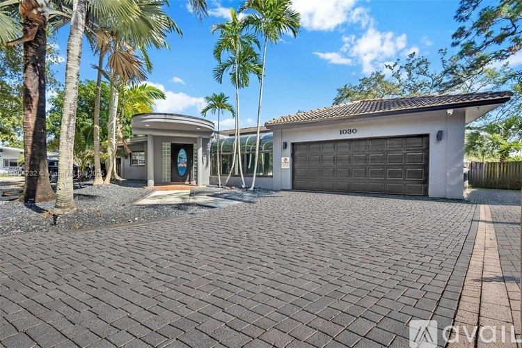 A house with a driveway and garage is for sale.
