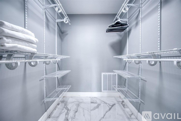 A storage room with shelves and towels.