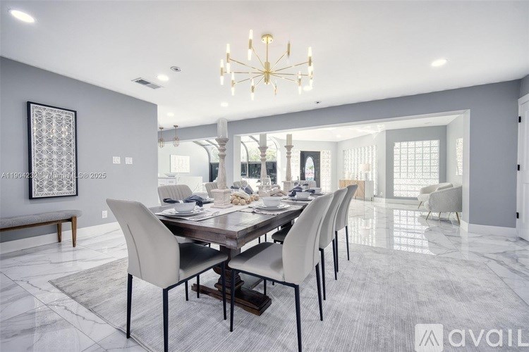 A modern dining room with a large table and chairs.