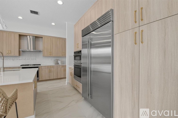 A modern kitchen with a stainless steel refrigerator and wooden cabinets.