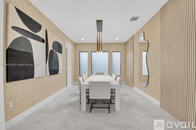 A modern dining room with a large table and chairs.