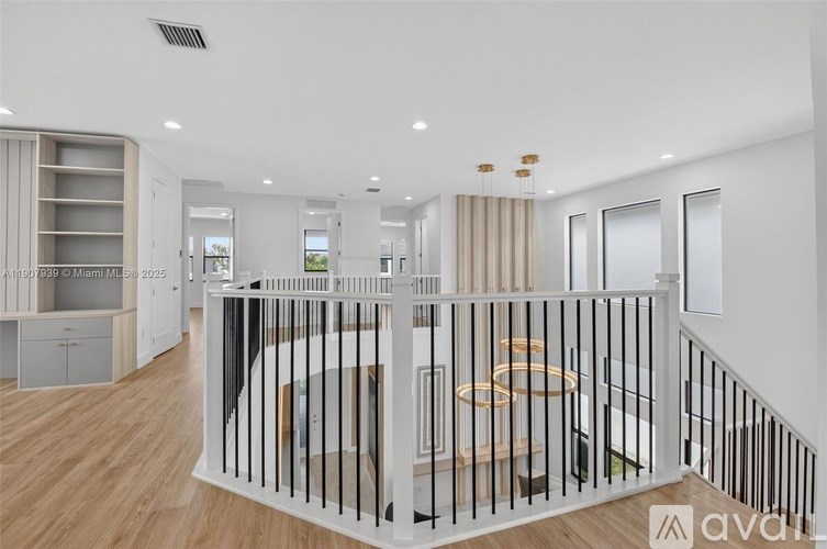 A modern living room with a staircase leading to the upper floor.