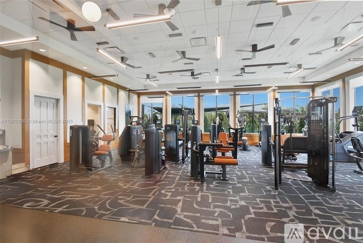A gym with a variety of equipment including treadmills, weights, and exercise machines.