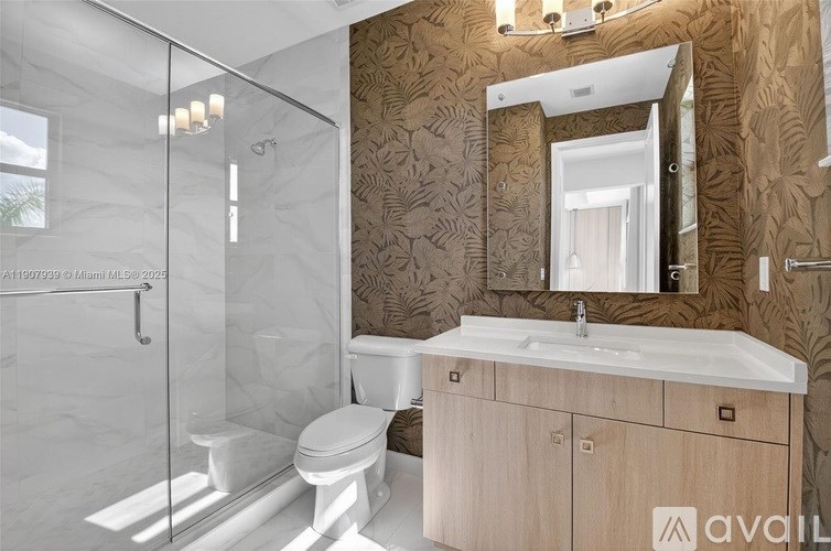 A bathroom with a toilet, sink, and mirror.