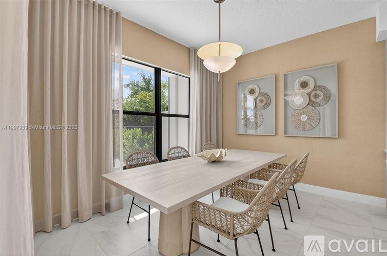 A dining room with a table and chairs.