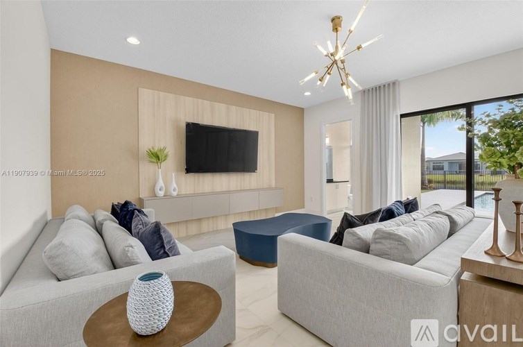 A modern living room with a grey sofa, a wooden coffee table, and a flat-screen TV mounted on the wall.
