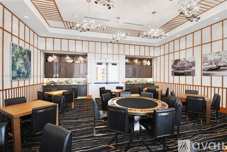 A room with a poker table surrounded by chairs.