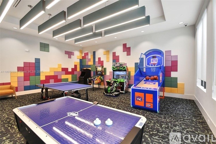 A room with a blue table tennis table in the center.