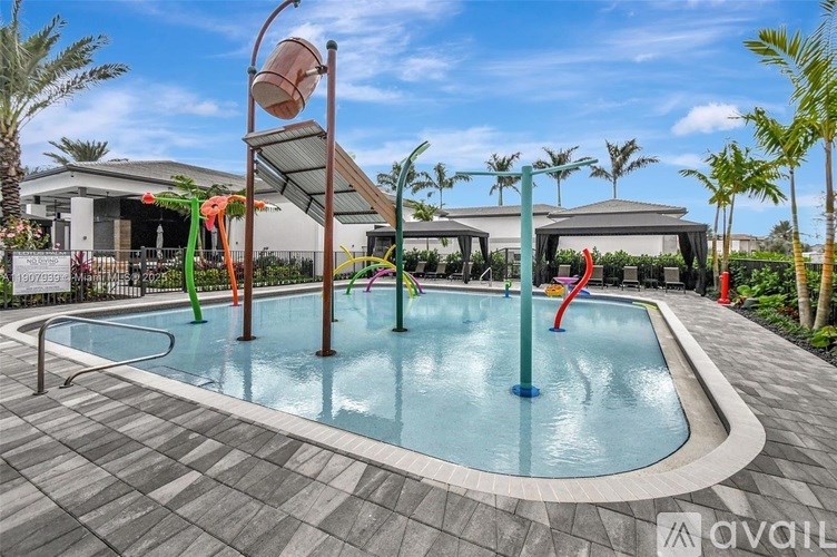 A pool with a slide and a sunshade.