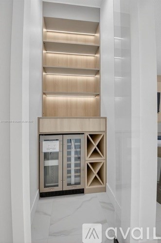 A modern kitchen with wooden cabinets and a glass door cabinet.