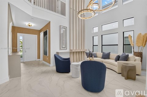 A modern living room with a blue chair in the foreground.