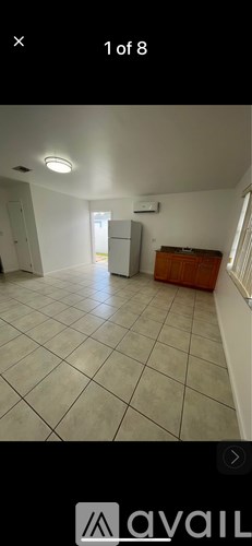 A room with white walls and a tiled floor.