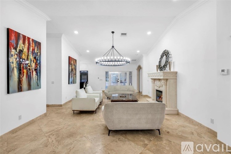 A living room with a large painting on the wall and a fireplace.