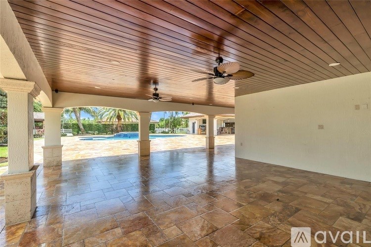 A room with a wooden ceiling and a fan.
