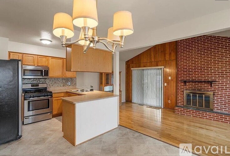 A kitchen with a black refrigerator, stove, and oven.