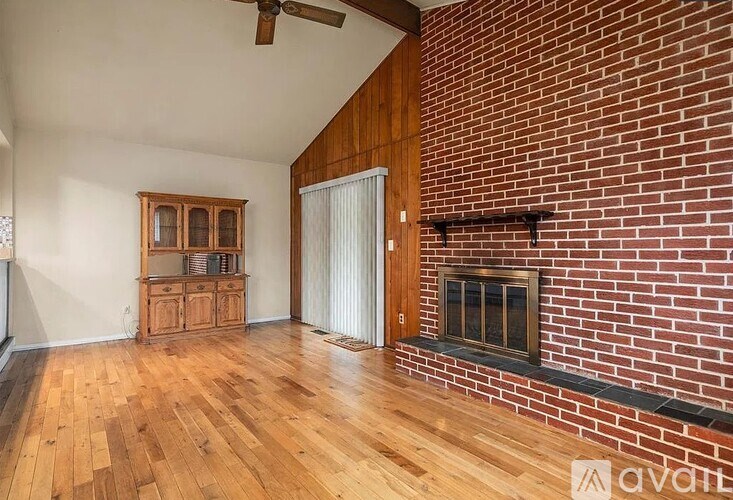A room with a fireplace and wooden floors.