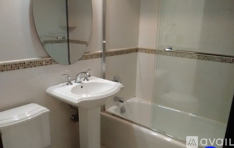 A white sink is on a stand in a bathroom.