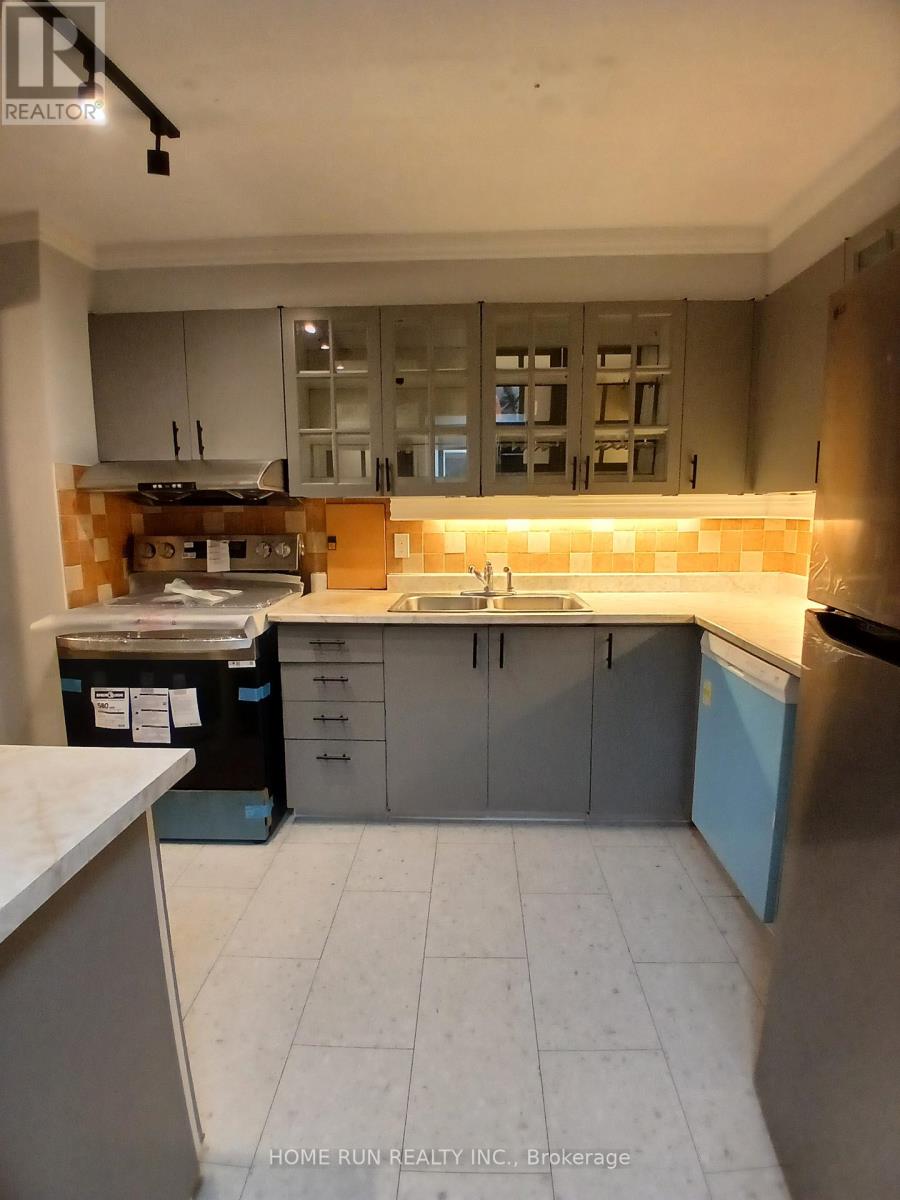 A kitchen with a blue refrigerator and a tiled floor.