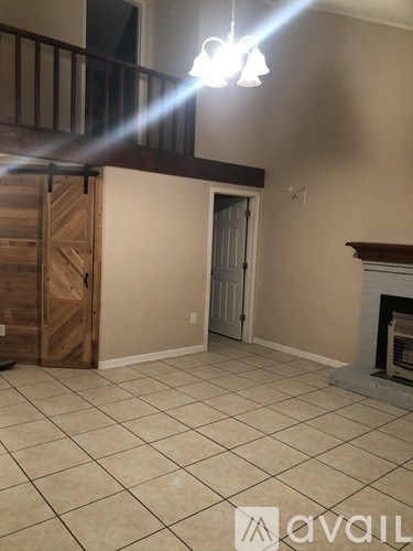 A room with a fireplace and a chandelier.