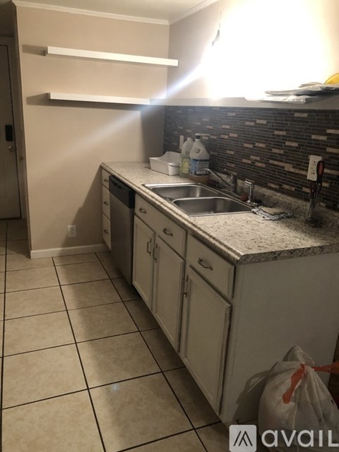 A kitchen with a sink and a counter.
