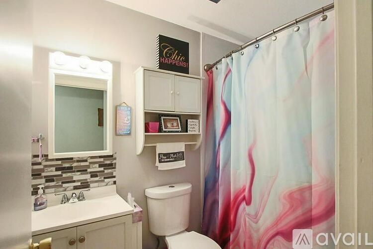 A bathroom with a shower curtain that has a marbled pattern.