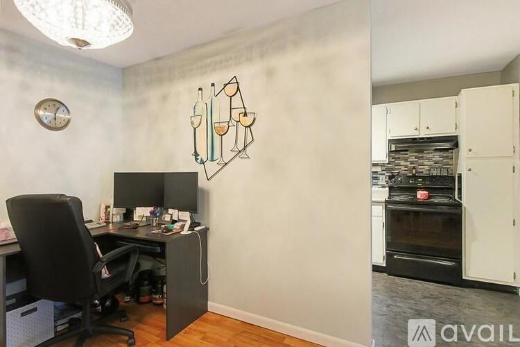 A room with a desk and a chair in it.