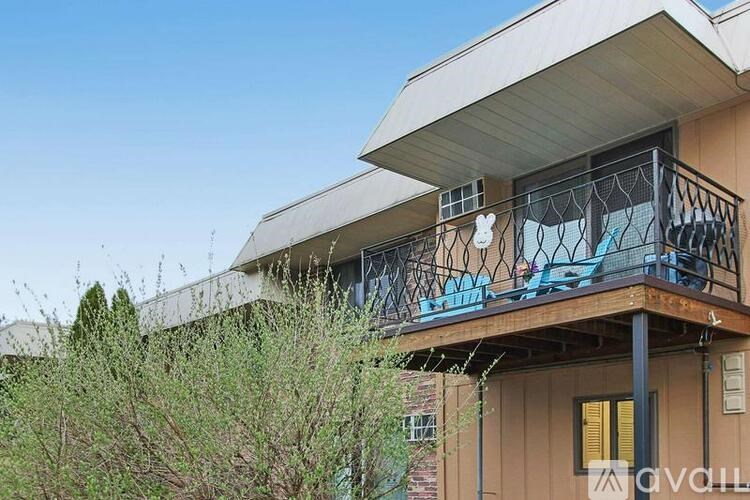 A balcony with a black railing and a white rabbit decoration.