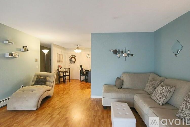 A living room with a couch, chair, and lamp.