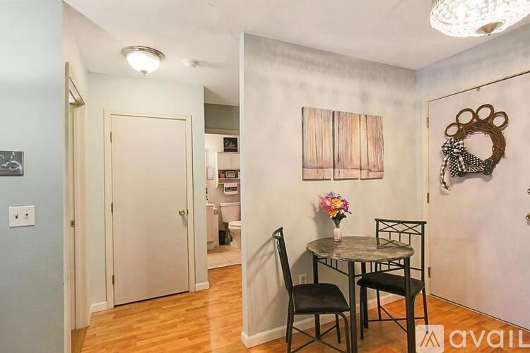 A dining room with a table and chairs.