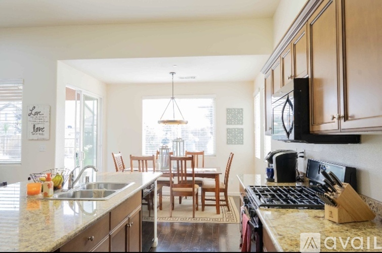 A kitchen with a table and chairs in the middle of the room.
