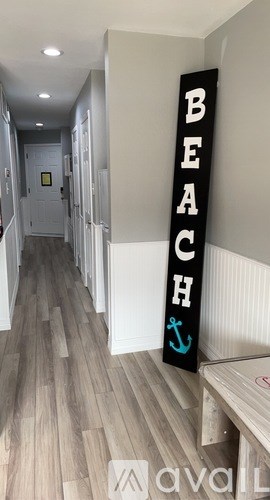 A hallway with a sign that says "BEACH" on it.