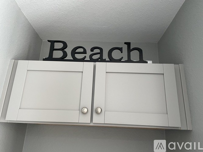 A white cabinet with the word "Beach" written above it.