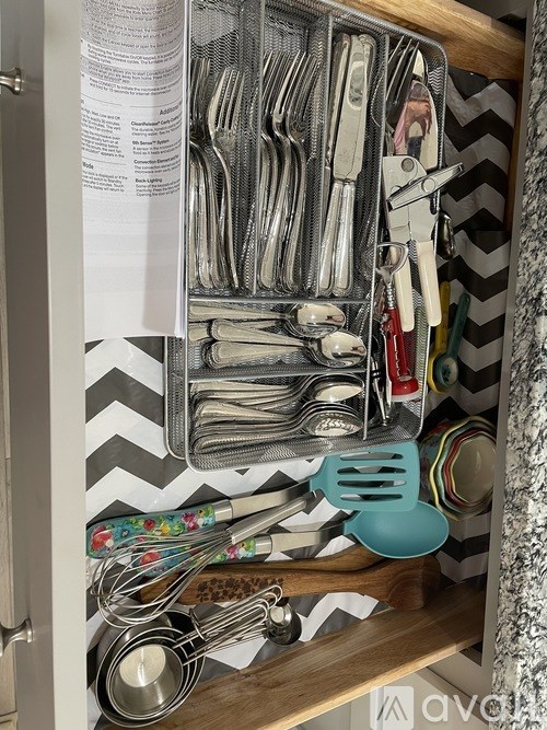 A drawer full of silverware and utensils.