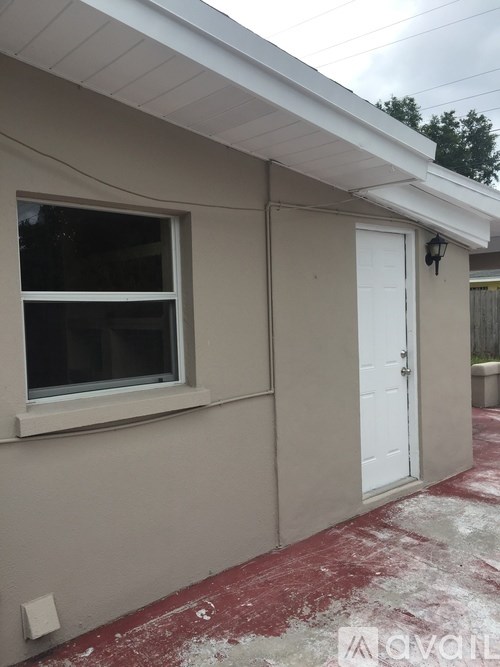 A house with a white door and window is shown.