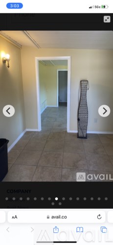 A room with a door and a wall-mounted light fixture.