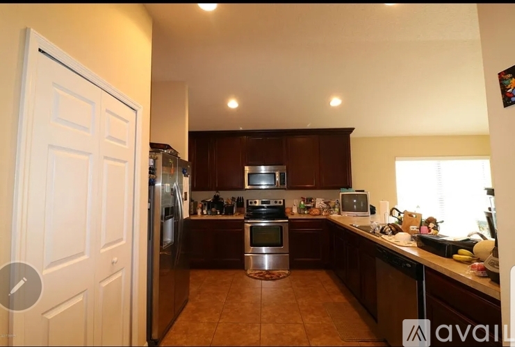 A kitchen with brown cabinets and a white door.