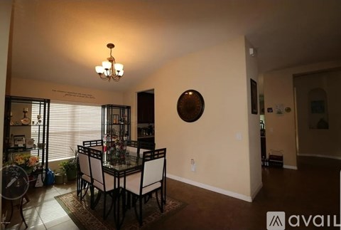 A dining room with a glass table and chairs.