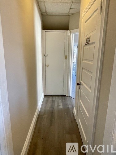 A hallway with a door on the right and a door on the left.