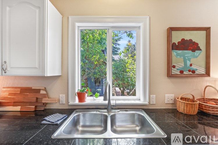 A kitchen with a double sink and a window.