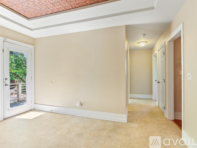 A room with beige walls and a white door.