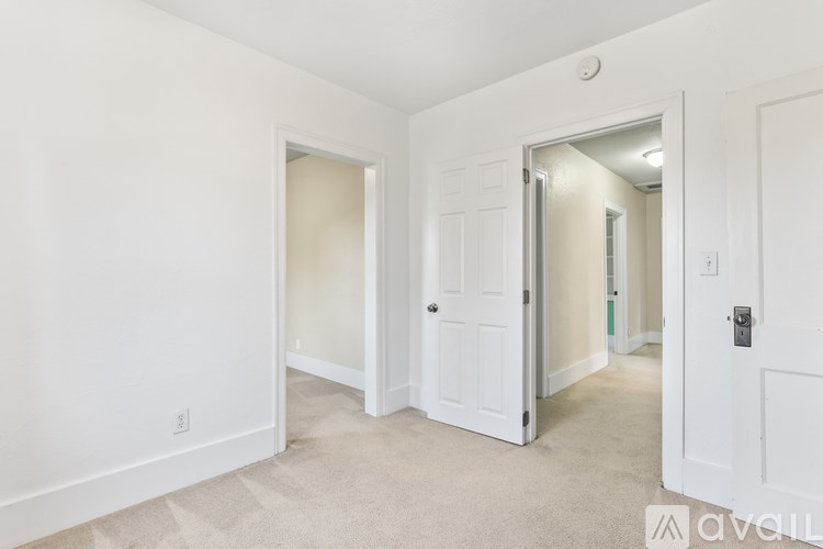 A white door is open to a hallway.
