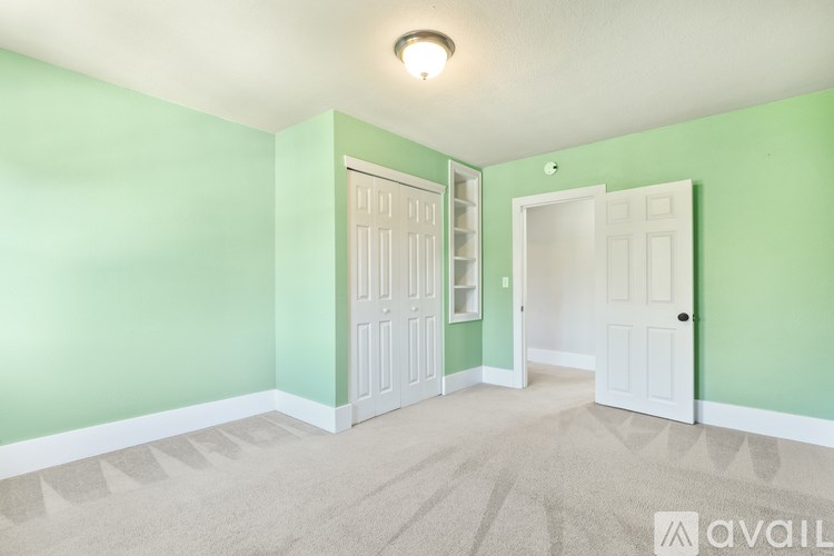 A room with two white doors and a carpeted floor.