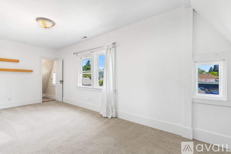 A room with white walls and a carpeted floor.