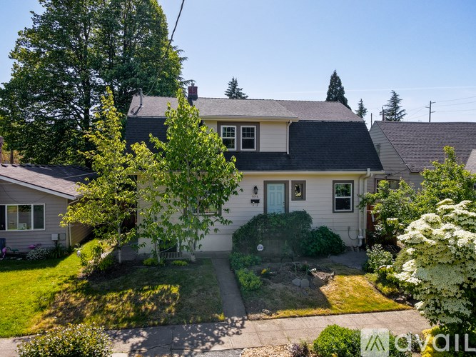 A house with a white door and a green lawn in front.