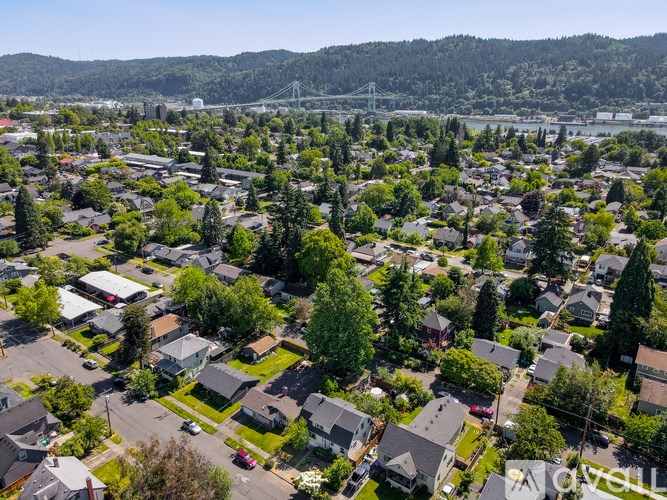 A small town with a bridge in the background.
