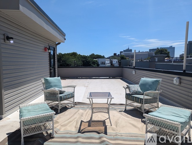 A patio with a table and chairs is set up on a rooftop.